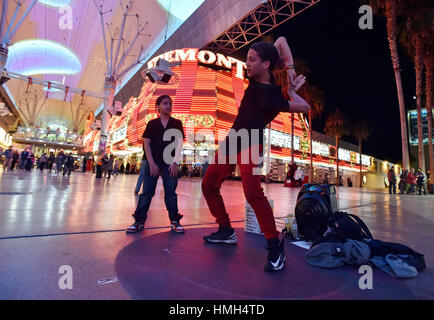 Las Vegas, Nevada, USA. 11th Jan, 2016. -Justin Arce, 11, left, and his brother Drew Arce, 15 perform their contortion and dance act at the Fremont Street Experience Monday, Jan. 11, 2016, in Las Vegas. Buskers and street performers are required register before performing on the pedestrian mall. Credit: David Becker/ZUMA Wire/Alamy Live News Stock Photo