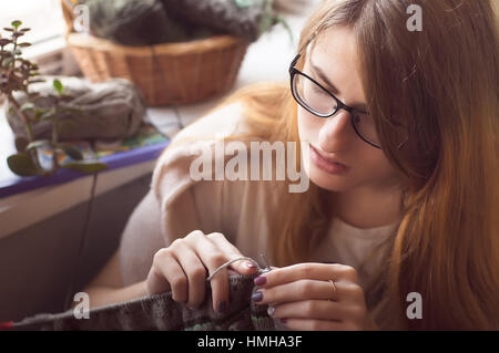 Woman hands knitting colorful wool yarn norway pattern. Close-up horizontal photo. Freelance creative working and living concept Stock Photo