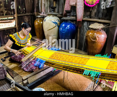 iban lady making rattan carpet Stock Photo