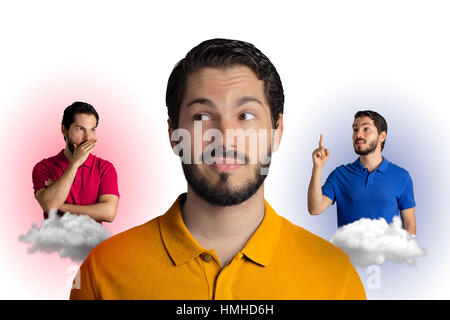 Young man is listening to inner voices. Divided between right and wrong.  White background.
