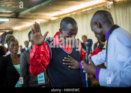 Pastor Chibwe Katebe exorcises the evil spirit from the body of a man during a Sunday service at the House of Prayer for All Nations in Livingstone, Zambia Stock Photo