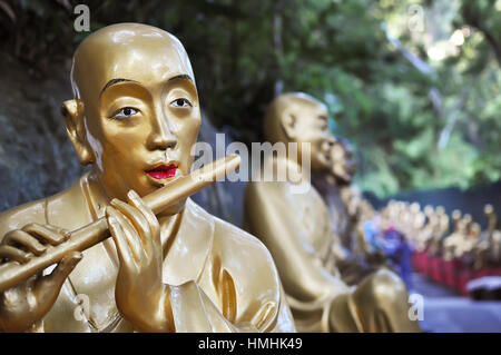 Flute playing statue at the Ten Thousand Buddhas Monastery, Hong Kong. Stock Photo