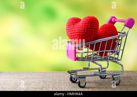 Red heart in shopping cart with nature background Stock Photo