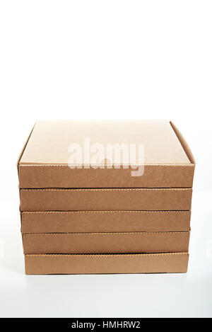 stack of new brown pizza boxes isolated on white Stock Photo