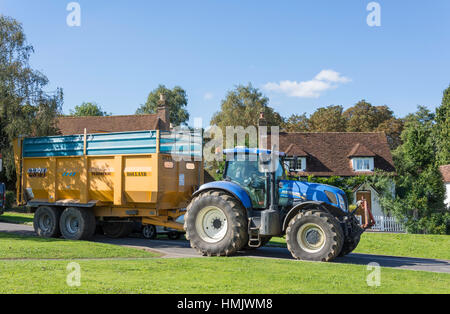 Tractor and trailer driving through Brockham Green, Brockham, Surrey, England, United Kingdom Stock Photo