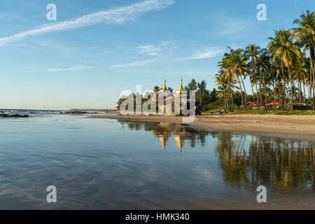 Golden pagodas on rocks at palm beach, Ngwe Saung, Myanmar Stock Photo