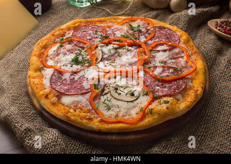 Delicious italian pizza served on sackcloth Stock Photo