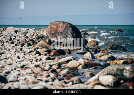 Stony coast of Baltic sea, selective focus on large stone Stock Photo