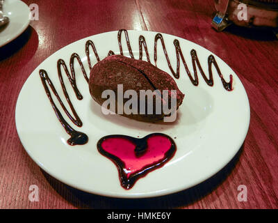 Chocolate cake on plate with jam heart Stock Photo