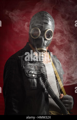 Scary man wearing authentic Russian gas mask with breathing hose Stock Photo