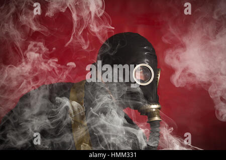 Scary man wearing authentic Russian gas mask with breathing hose Stock Photo