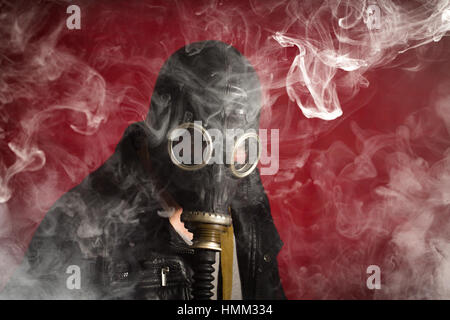 Scary man wearing authentic Russian gas mask with breathing hose Stock Photo