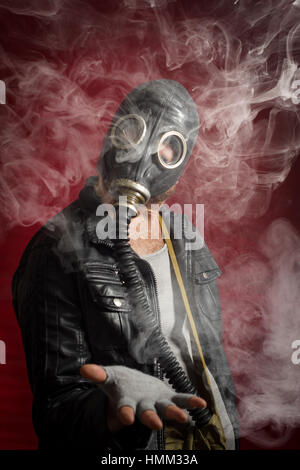 Scary man wearing authentic Russian gas mask with breathing hose Stock Photo