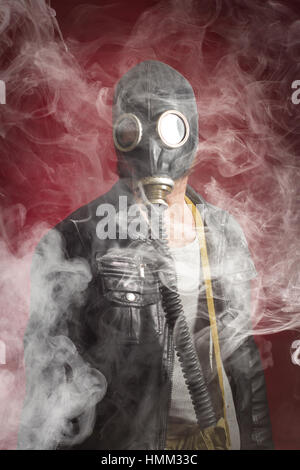 Scary man wearing authentic Russian gas mask with breathing hose Stock Photo