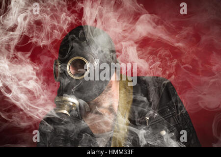 Scary man wearing authentic Russian gas mask with breathing hose Stock Photo