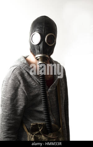 Scary man wearing authentic Russian gas mask with breathing hose Stock Photo