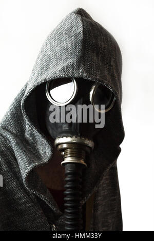 Scary man wearing authentic Russian gas mask with breathing hose Stock Photo