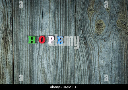 Words of hope from small multi-colored wooden letters, empty space on the right Stock Photo