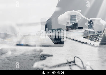 Double exposure of Photo website graphic designer hand meeting team with new project modern studio.Modern laptop digital tablet smart phone with Londo Stock Photo