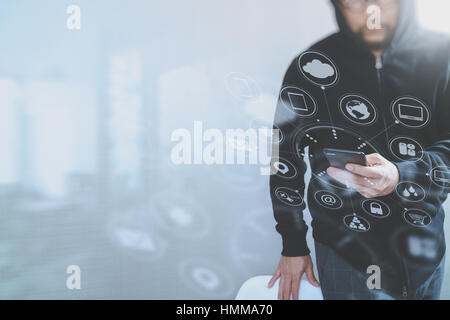 hipster male in a hood hand using mobile phone payments online shopping,omni channel,front view,icons graphic virtual interface screen,eyeglass Stock Photo