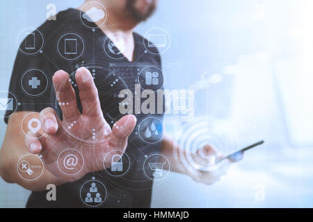 Designer hand pressing an imaginary button,holding smart phone,virtual digital screen graphic icons,graph,diagram interface computer,filter effect Stock Photo