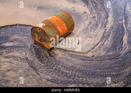 Old rusty barrel oil on beach Stock Photo