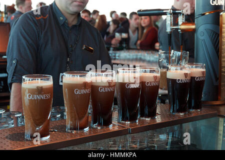 DUBLIN, IRELAND - FEB 15, 2014: Pints of beer are served at the popular Guinness Brewery on Feb 15, 2014. The brewery where 2.5 million pints of stout Stock Photo