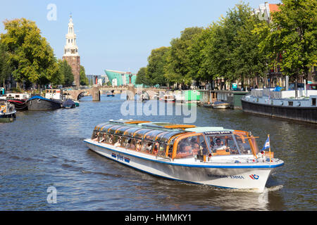 AMSTERDAM, NETHERLANDS - AUG 27, 2014: Canal boat in one of the canals in Amsterdam. The city is the worlds most watery city. It has more than one hun Stock Photo