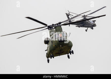 LEEUWARDEN, THE NETHERLANDS - JUN 10, 2016: Dutch Chinook and Apache helicopter flying during the Royal Netherlands Air Force Days Stock Photo