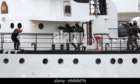 DEN HELDER, THE NETHERLANDS - JUNE 23: Dutch Marines entering a ship during an anti piracy demonstrion at the Dutch Navy Days on June 23, 2013 in Den  Stock Photo