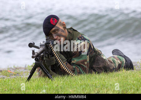 DEN HELDER, THE NETHERLANDS - JUNE 23: Dutch Marine machinegunner during an amphibious assault demo during the Dutch Navy Days on June 23, 2013 in Den Stock Photo