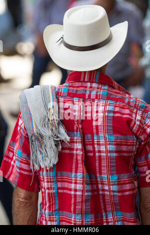 man wearing traditional Colombian straw hat and poncho over his sholder in the coffee town of El Jardin Stock Photo
