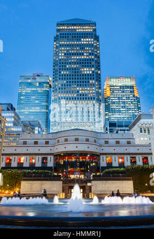 LONDON - AUGUST 21: Cabot Square in the modern Canary Wharf quarter with its banks and skyscrapers at night on August 21, 2013 Stock Photo