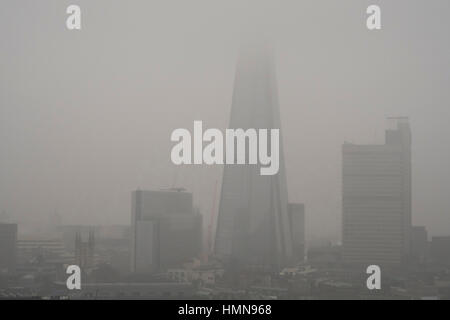 London, UK. 10th Feb, 2017. Low visibility with tall buildings obscured, drizzle and bitter wind in grey central London. Top of The Shard hidden in low cloud and mist. Credit: Malcolm Park editorial/Alamy Live News