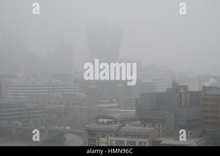 London, UK. 10th Feb, 2017. Low visibility with tall buildings obscured, drizzle and bitter wind in grey central London. Credit: Malcolm Park editorial/Alamy Live News