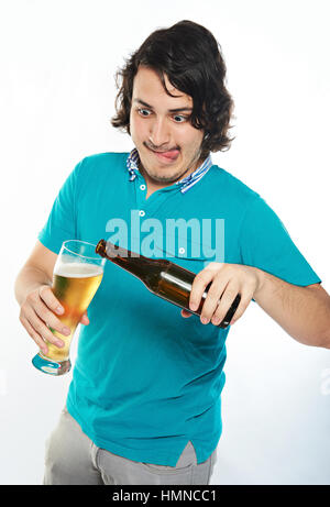 funny man pouring beer in glass isolated on white Stock Photo
