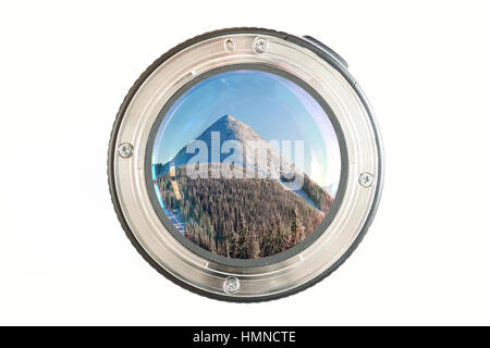 Camera photo lens close-up on white background with lense reflections and panorama view of snow covered mountain in winter