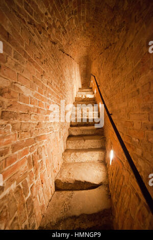 Narrow staircase old brick arched long corridor in Royal Castle of Warsaw in Poland, Europe Stock Photo