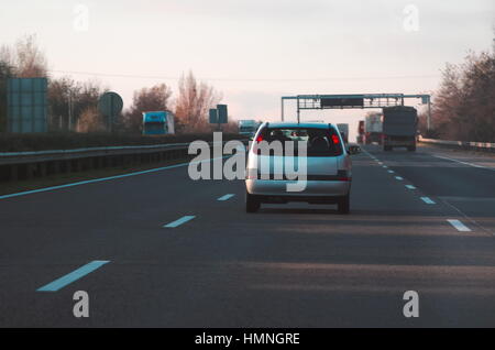 Silver Car on the Motorway Early Evening Stock Photo