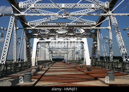 A jogger crosses the Shelby Ave Pedestrian Bridge over the Cumberland River, Nashville, Tennessee Stock Photo