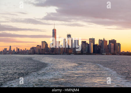 Manhattan island at dawn photographed from the Staten island Ferry, New York City, United States of America. Stock Photo