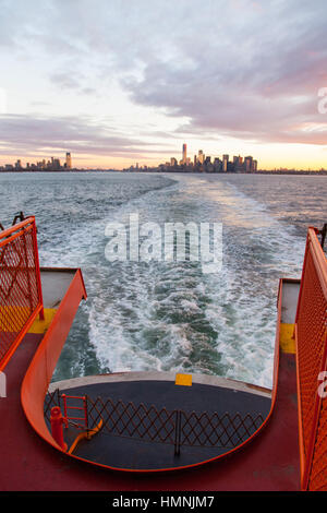 Manhattan island at dawn photographed from the Staten island Ferry, New York City, United States of America. Stock Photo