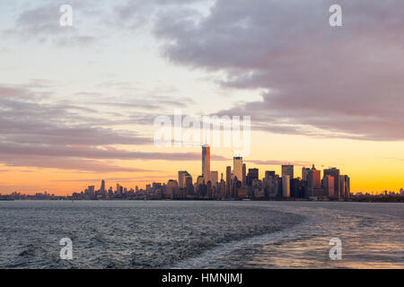 Manhattan island at dawn photographed from the Staten island Ferry, New York City, United States of America. Stock Photo