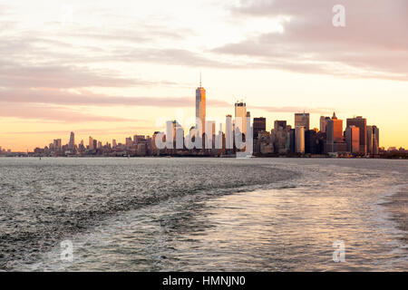 Manhattan island at dawn photographed from the Staten island Ferry, New York City, United States of America. Stock Photo