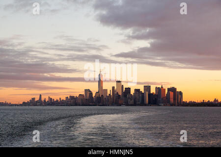 Manhattan island at dawn photographed from the Staten island Ferry, New York City, United States of America. Stock Photo