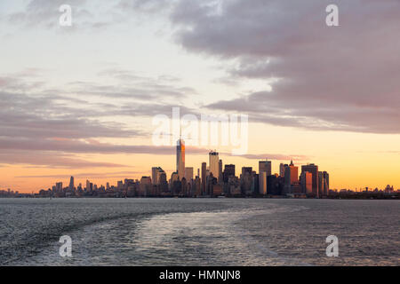 Manhattan island at dawn photographed from the Staten island Ferry, New York City, United States of America. Stock Photo