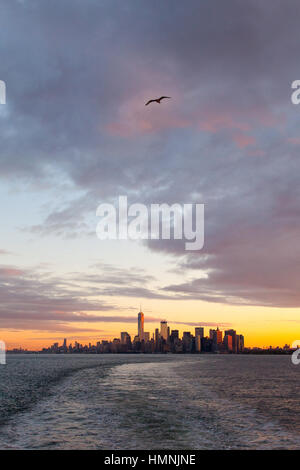 Manhattan island at dawn photographed from the Staten island Ferry, New York City, United States of America. Stock Photo