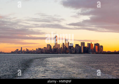 Manhattan island at dawn photographed from the Staten island Ferry, New York City, United States of America. Stock Photo