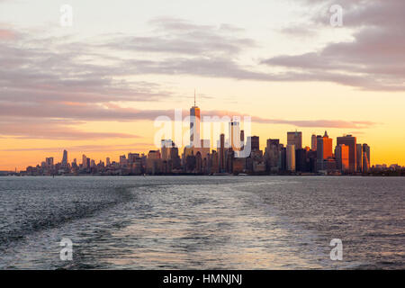 Manhattan island at dawn photographed from the Staten island Ferry, New York City, United States of America. Stock Photo