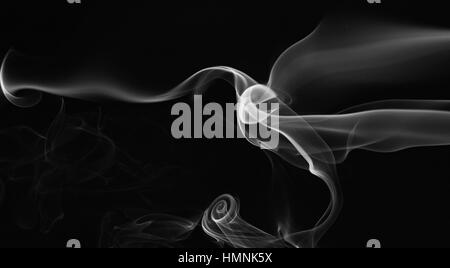 abstract gray smoke swirls isolated on black Stock Photo